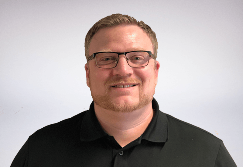 senior account executive at busybusy wearing black polo and glasses with facial hair