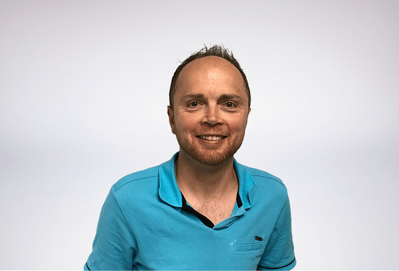 data analyst wearing blue polo with spiked hair